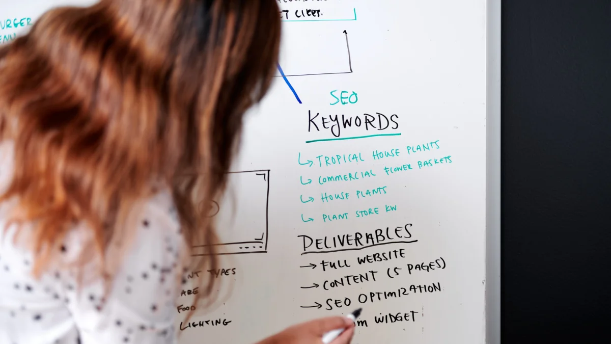 Woman writing on whiteboard